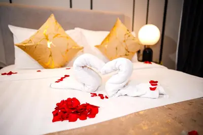 two towels in the shape of hearts on a bed at Axon Residences KLCC - CR Homestay in Kuala Lumpur