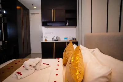 a bedroom with two towels on a bed at Axon Residences KLCC - CR Homestay in Kuala Lumpur