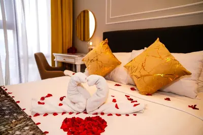 two swans made out of roses on a bed at Axon Residences KLCC - CR Homestay in Kuala Lumpur