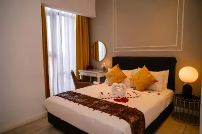 a hotel room with a bed with a stuffed animal on it at Axon Residences KLCC - CR Homestay in Kuala Lumpur
