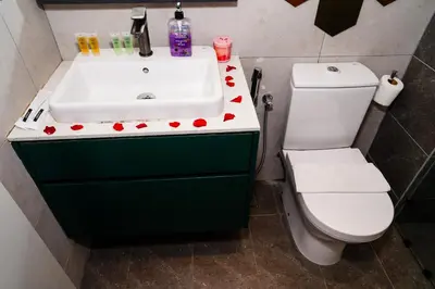 a bathroom with a sink and a toilet at Axon Residences KLCC - CR Homestay in Kuala Lumpur
