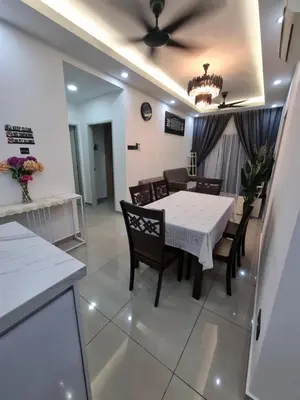 a dining room with a white table and chairs at Awani3 Homestay Setapak, KL in Kuala Lumpur