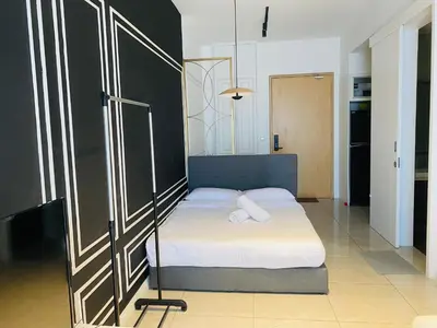 a bedroom with a bed with a white sheet at Axon Residence premium Apartment KL in Kuala Lumpur