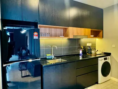 a kitchen with a sink and a washing machine at Axon Residence premium Apartment KL in Kuala Lumpur