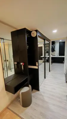 a room with a black cabinet and a living room at pertama residency jacuzzi projector 120