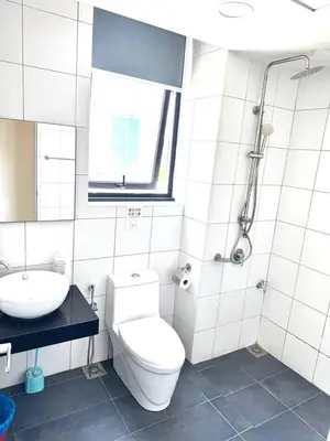 a white bathroom with a toilet and a sink at Chamber Luxury Suites Kuala Lampur in Kuala Lumpur