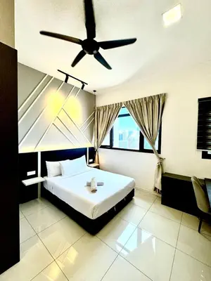 a bedroom with a bed and a ceiling fan at Chamber Luxury Suites Kuala Lampur in Kuala Lumpur