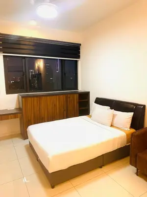 a bedroom with a large bed and a window at Chamber Luxury Suites Kuala Lampur in Kuala Lumpur
