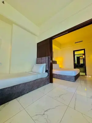 two beds in a room with a large mirror at Times Square Services suite at kl Bukit Bintang SAkL in Kuala Lumpur