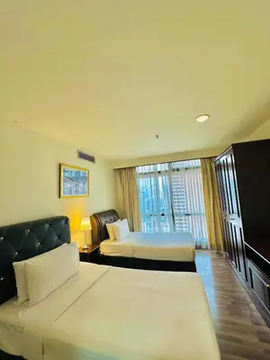 a hotel room with two beds and a window at Times Square Services suite at kl Bukit Bintang SAkL in Kuala Lumpur