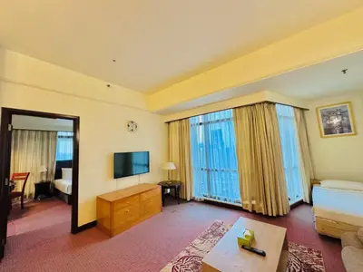 a large hotel room with a bed and a television at Times Square Services suite at kl Bukit Bintang SAkL in Kuala Lumpur