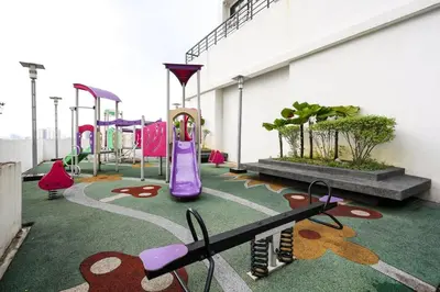 a play area with a playground with a purple slide at One Maxim Sentul By LuxeStay in Kuala Lumpur