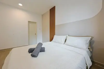a bedroom with a bed with a towel on it at One Maxim Sentul By LuxeStay in Kuala Lumpur