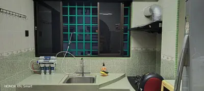 a small kitchen with a sink and a mirror at Hot Spring Residential in Kuala Lumpur