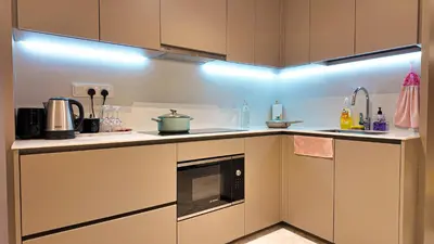 a kitchen with a sink and a microwave at Eaton Residences KLCC- JD World Homestay in Kuala Lumpur