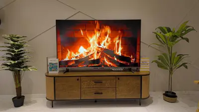 a tv sitting on a stand with a fire on it at Eaton Residences KLCC- JD World Homestay in Kuala Lumpur