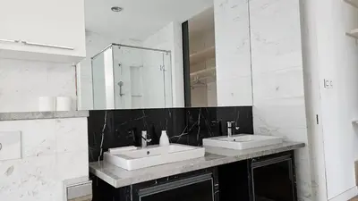a bathroom with two sinks and a mirror at Platinum Executive Suites Kuala Lumpur in Kuala Lumpur