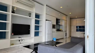 a living room with two chairs and a television at Platinum Executive Suites Kuala Lumpur in Kuala Lumpur