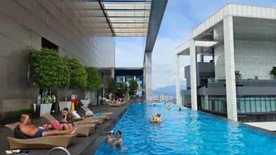a pool in a building with people in the water at Platinum Executive Suites Kuala Lumpur in Kuala Lumpur