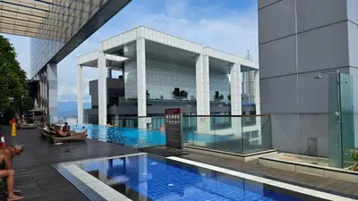a building with a swimming pool in front of a building at Platinum Executive Suites Kuala Lumpur in Kuala Lumpur