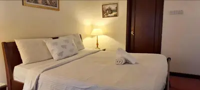 a bedroom with a white bed with a towel on it at Times square in Kuala Lumpur