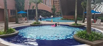 a person playing in a large pool in a building at Times square in Kuala Lumpur