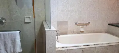 a bathroom with a bath tub and a towel at Times square in Kuala Lumpur