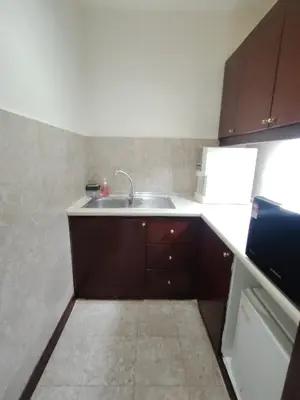 a small kitchen with a sink and a refrigerator at Kuala Lumpur City Apartment Times Square in Kuala Lumpur