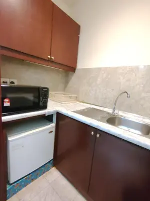 a kitchen with a sink and a microwave at Kuala Lumpur City Apartment Times Square in Kuala Lumpur
