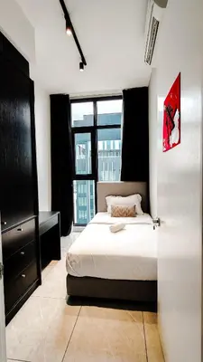 a bedroom with a bed and a large window at Axon Residence Bukit Bintang by Mia in Kuala Lumpur