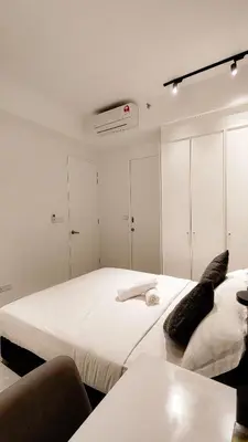 two beds in a room with white walls at Axon Residence Bukit Bintang by Mia in Kuala Lumpur