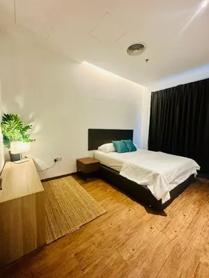 a bedroom with a bed and a black curtain at Premium One Bedroom Condo at Bangsar Trade Centre in Kuala Lumpur