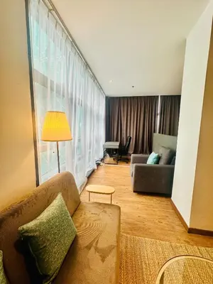 a living room with a couch and a large window at Premium One Bedroom Condo at Bangsar Trade Centre in Kuala Lumpur