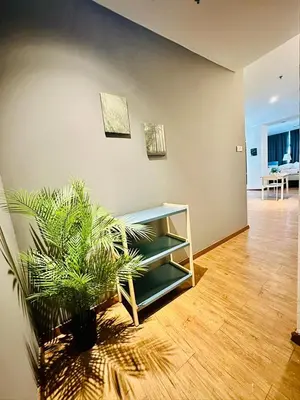 a living room with a potted plant and a table at Premium One Bedroom Condo at Bangsar Trade Centre in Kuala Lumpur