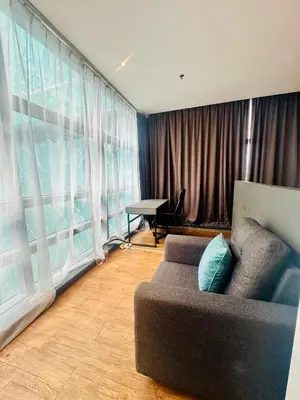 a living room with a couch and a large window at Premium One Bedroom Condo at Bangsar Trade Centre in Kuala Lumpur