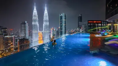 a pool on top of a building with a city skyline at Imperial Residences KLCC - JD World Homestay in Kuala Lumpur