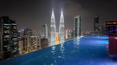 a pool on the roof of a building with a city skyline at Imperial Residences KLCC - JD World Homestay in Kuala Lumpur