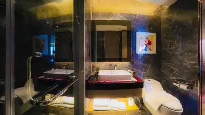 a bathroom with a sink and a toilet and a mirror at Imperial Residences KLCC - JD World Homestay in Kuala Lumpur