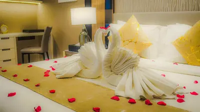two swans made out of hearts on a bed at Imperial Residences KLCC - JD World Homestay in Kuala Lumpur