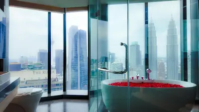 a bathroom with a tub with a view of a city at Imperial Residences KLCC - JD World Homestay in Kuala Lumpur