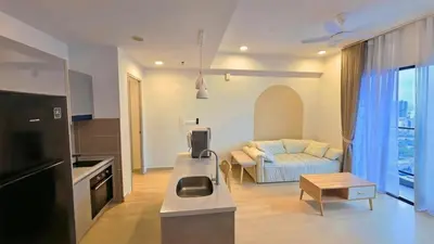 a kitchen and living room with a couch and a table at Trion KL Skyline Suites in Kuala Lumpur
