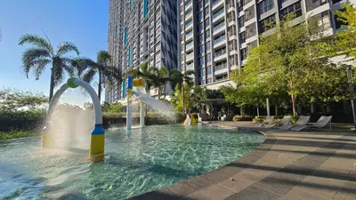 a water fountain in a pool in a city at Trion KL Skyline Suites in Kuala Lumpur
