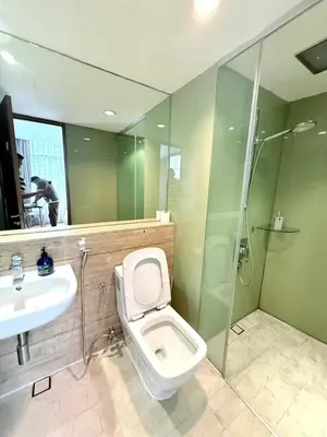 a bathroom with a toilet and a sink and a shower at Vortex Suites klcc by Natasya in Kuala Lumpur
