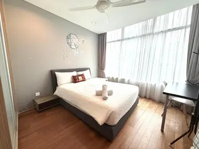 a bedroom with a bed with two teddy bears on it at Vortex Suites klcc by Natasya in Kuala Lumpur