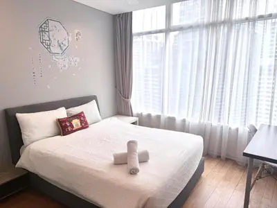 a bedroom with a bed with a teddy bear on it at Vortex Suites klcc by Natasya in Kuala Lumpur