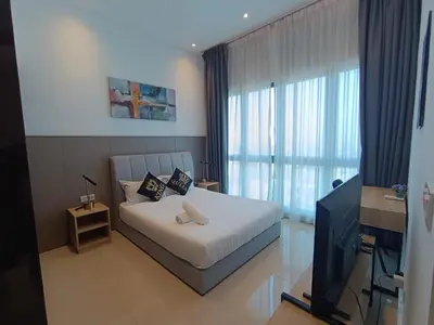 a bedroom with a bed and a television in a room at The Wisma INFINITUM BY KL in Kuala Lumpur