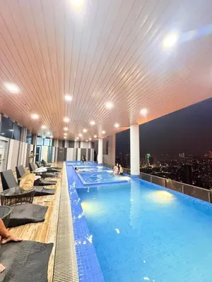 a large swimming pool on the top of a building at The Wisma INFINITUM BY KL in Kuala Lumpur