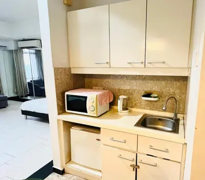 a small kitchen with a microwave and a sink at Max suites in Kuala Lumpur