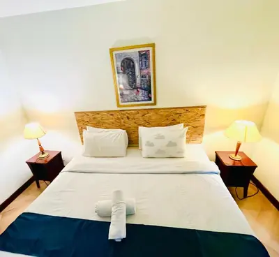 a bedroom with a large bed with two lamps at Max suites in Kuala Lumpur