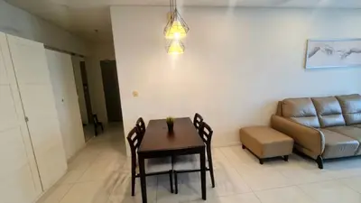 a living room with a table and a couch at Summer Suites Residences KLCC in Kuala Lumpur